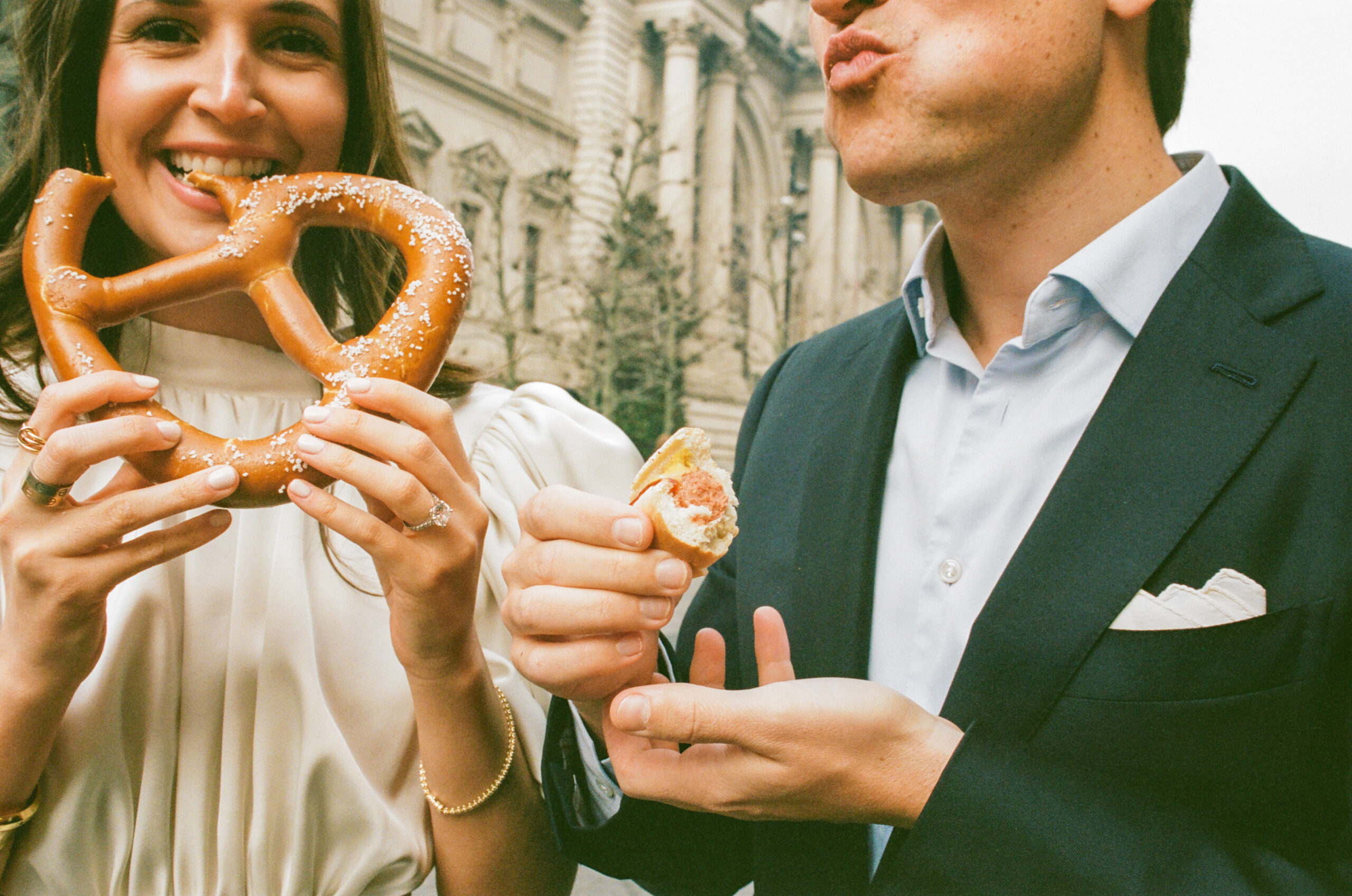 couple with hot dog and pretzel engagement photo at the on the upper east side shot on film by parkers pictures