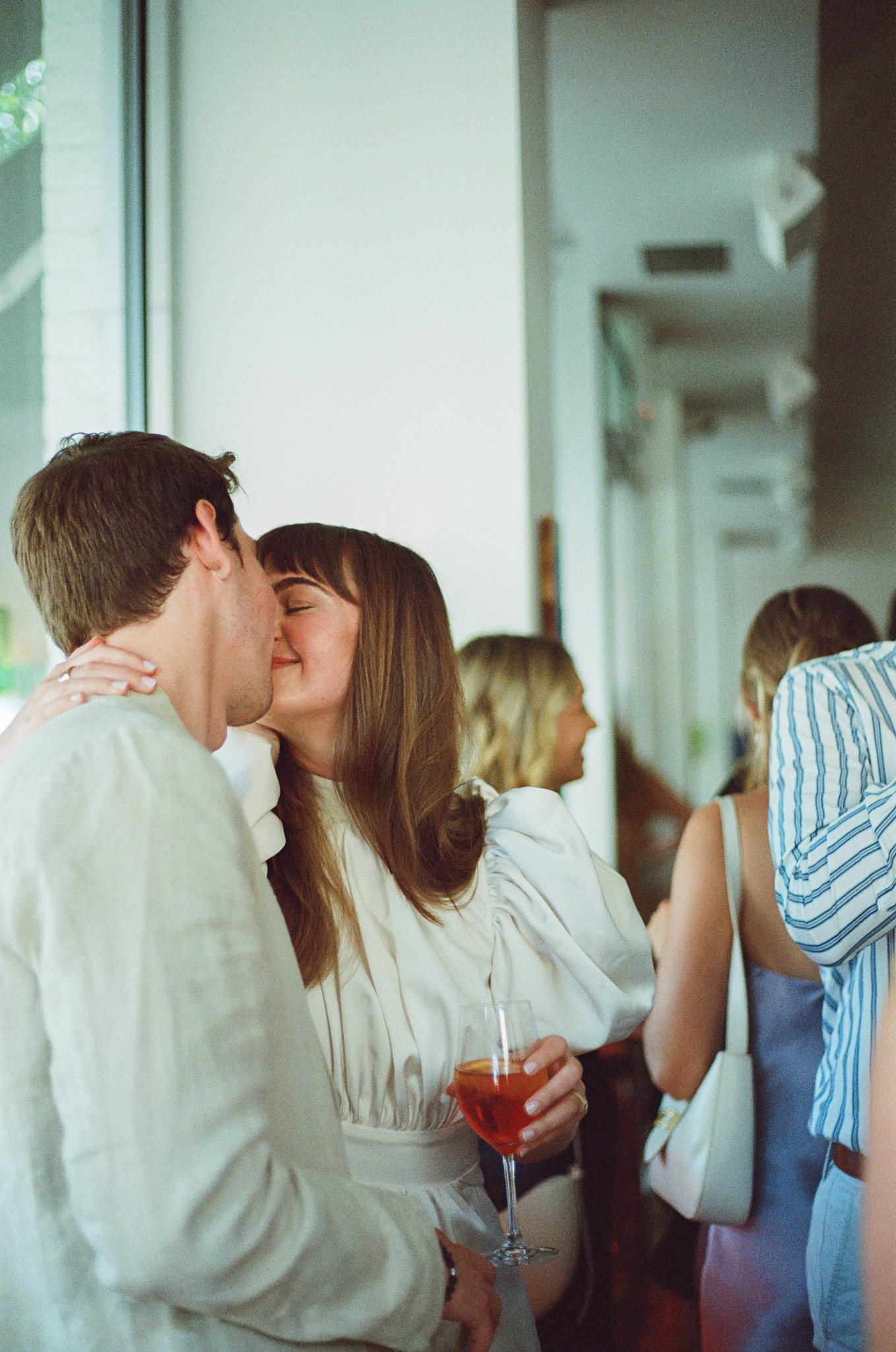 nyc engagement party couple kissing shot on 35mm film by parkers pictures