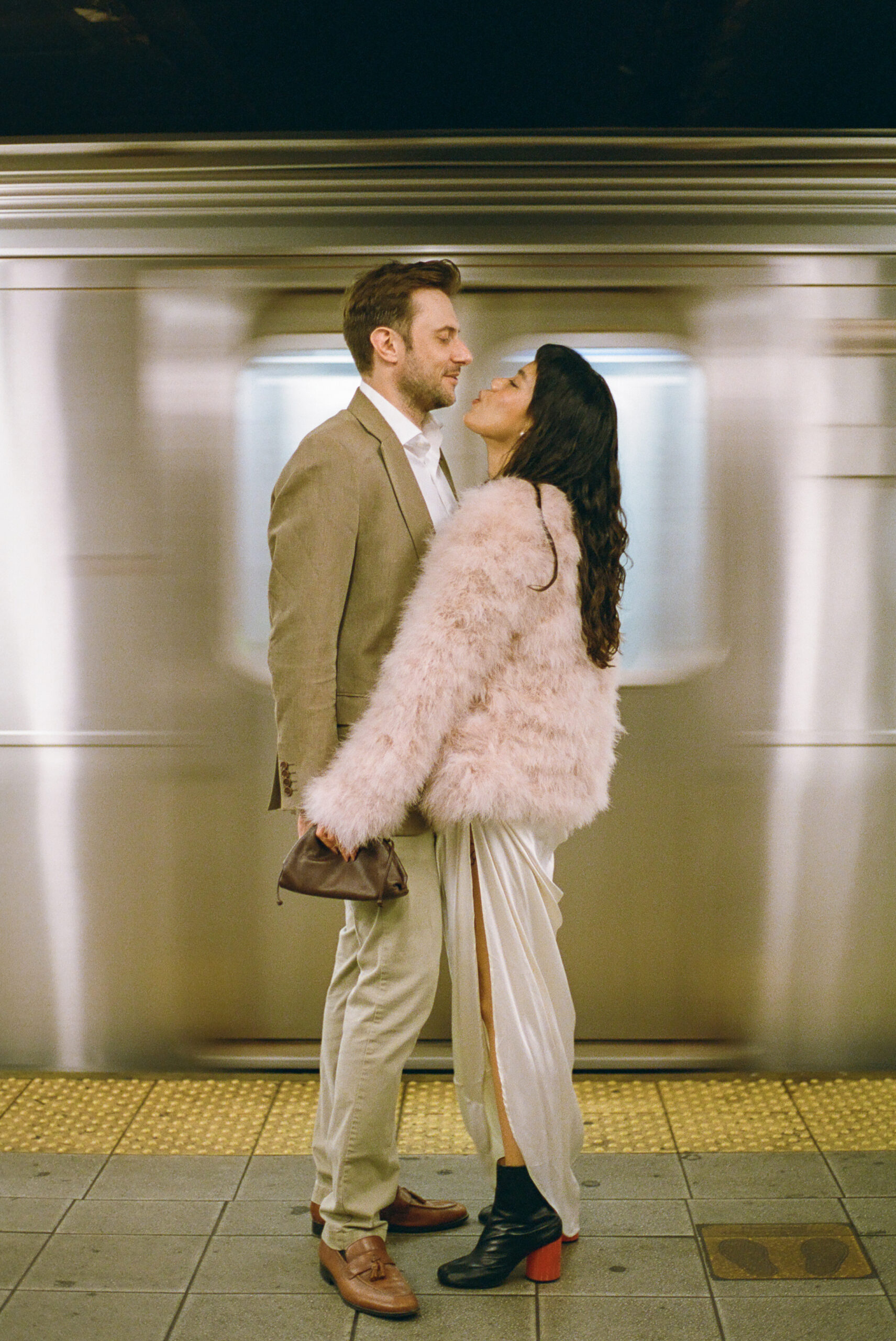 couple on subway engagement photo on subway platform shot on film by parkers pictures