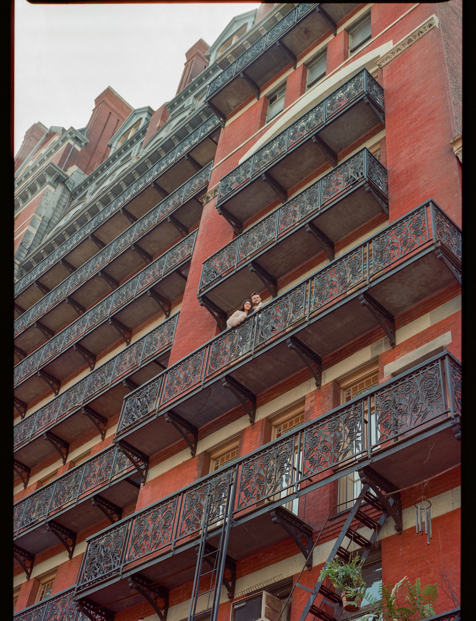 couple on the balcony of the chelsea hotel shot on medium format film by parkers pictures