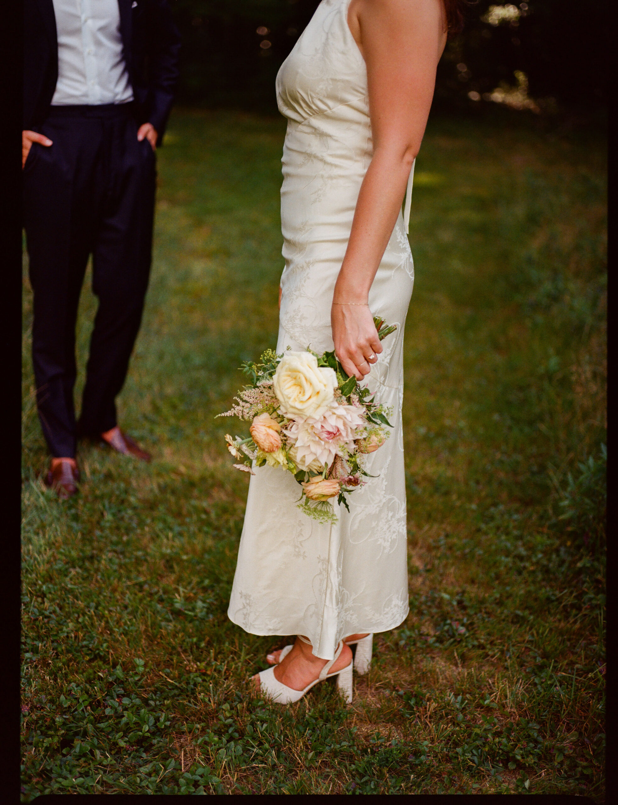 couple in a wildflower field in duxbury Massachusetts wedding shot on medium format film by parkers pictures