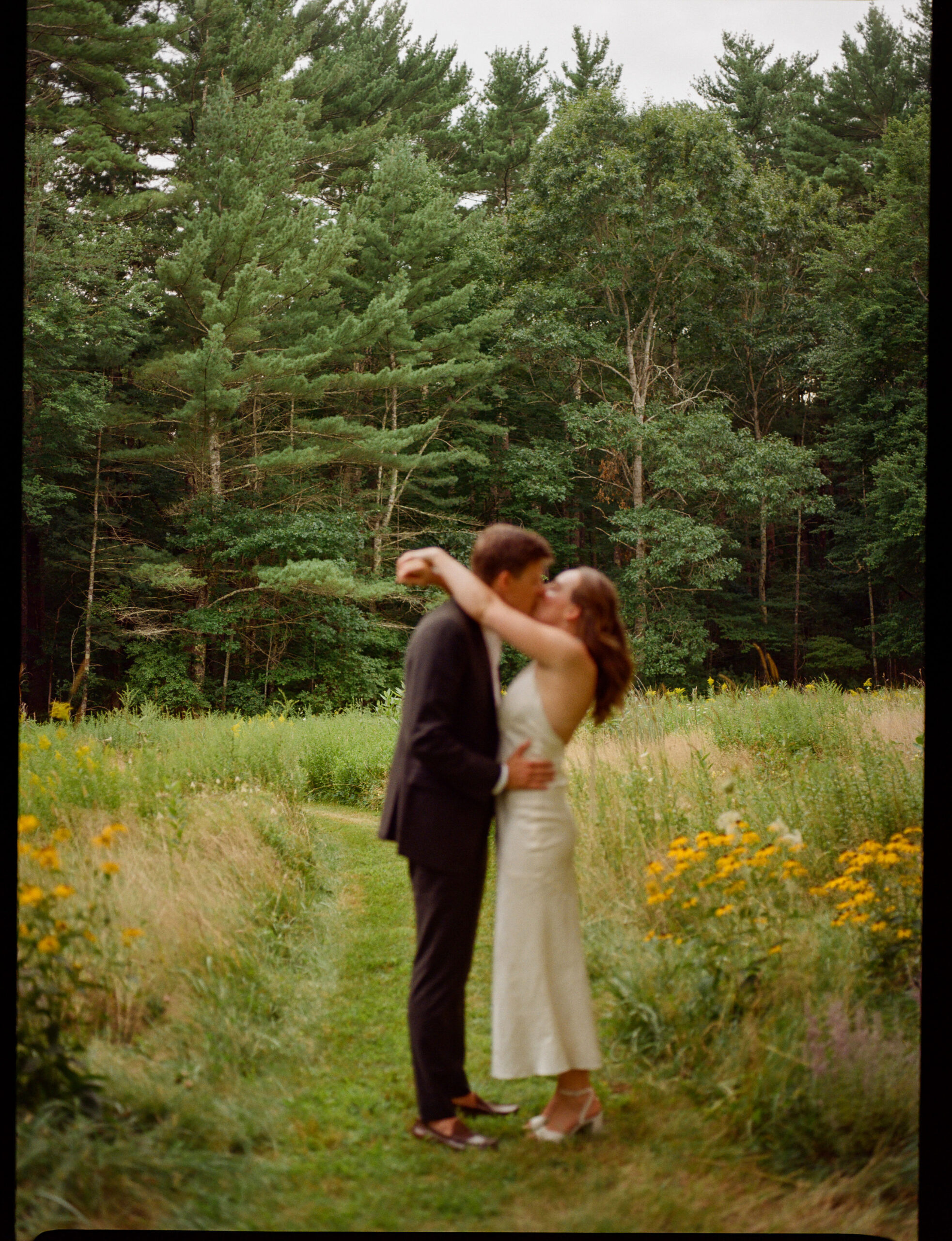 couple in a wildflower field in duxbury Massachusetts wedding shot on medium format film by parkers pictures