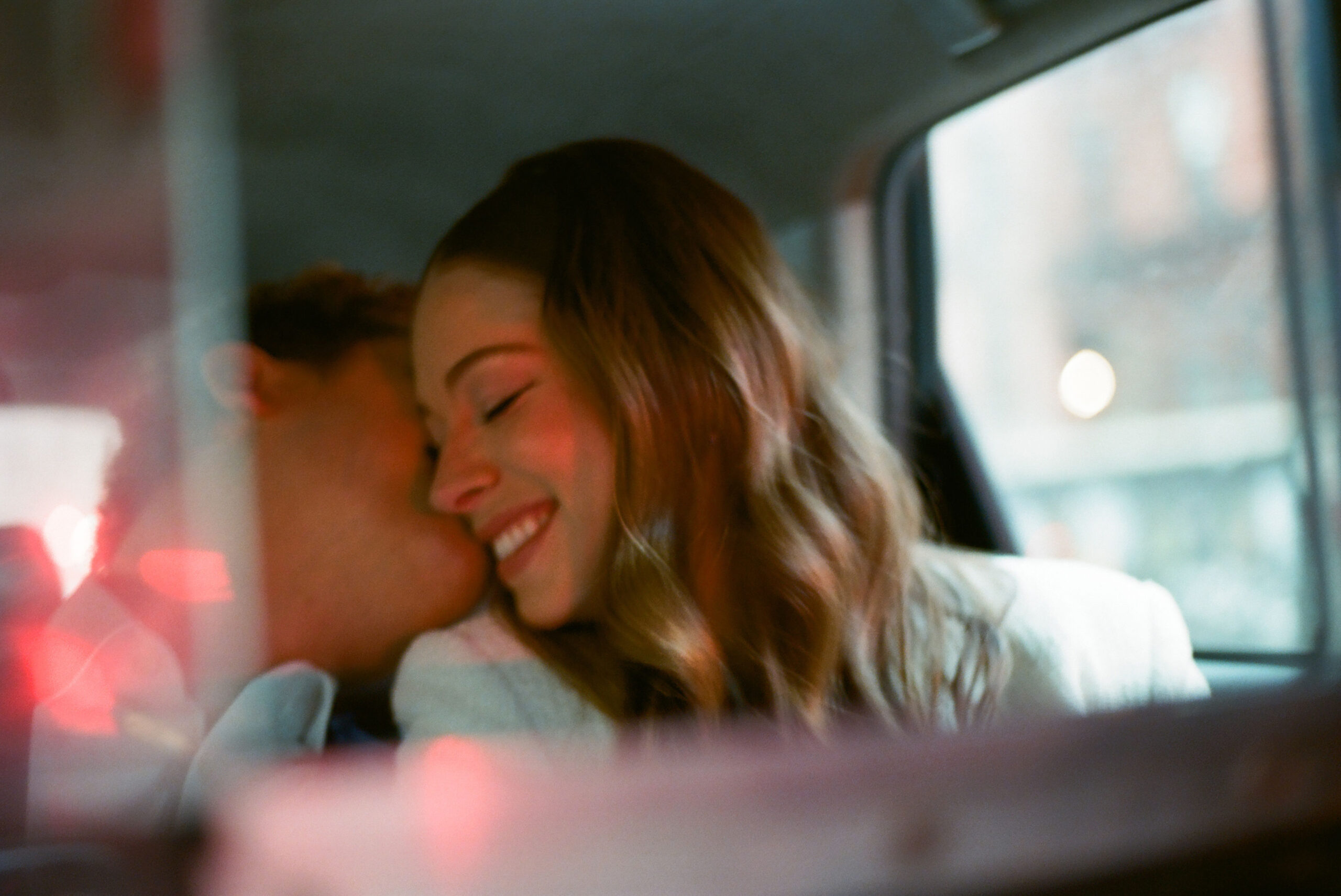 couple in the back of a nyc taxi shot on film by parkers pictures