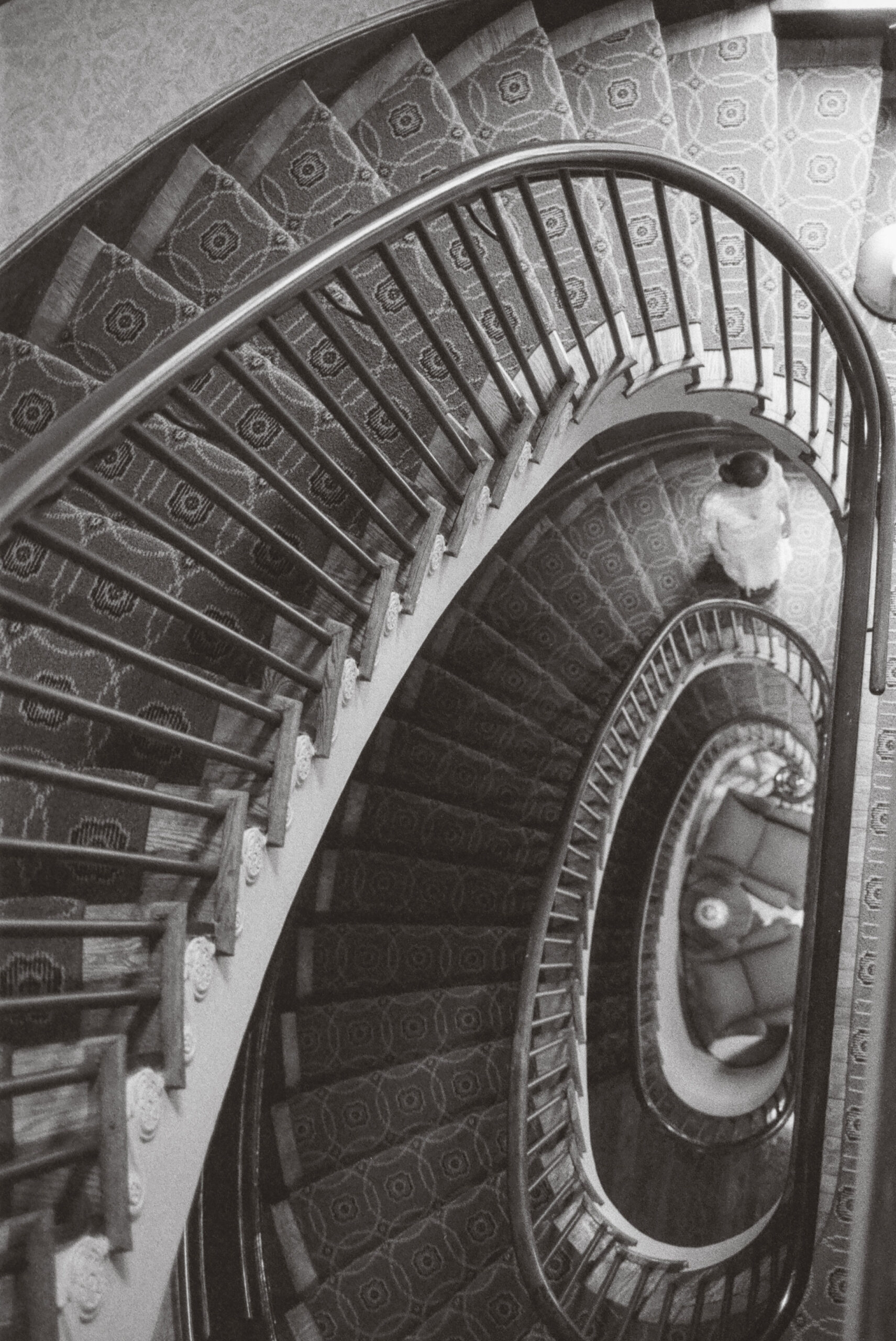 bride on spiral staircase shot on black and white film by parkers pictures