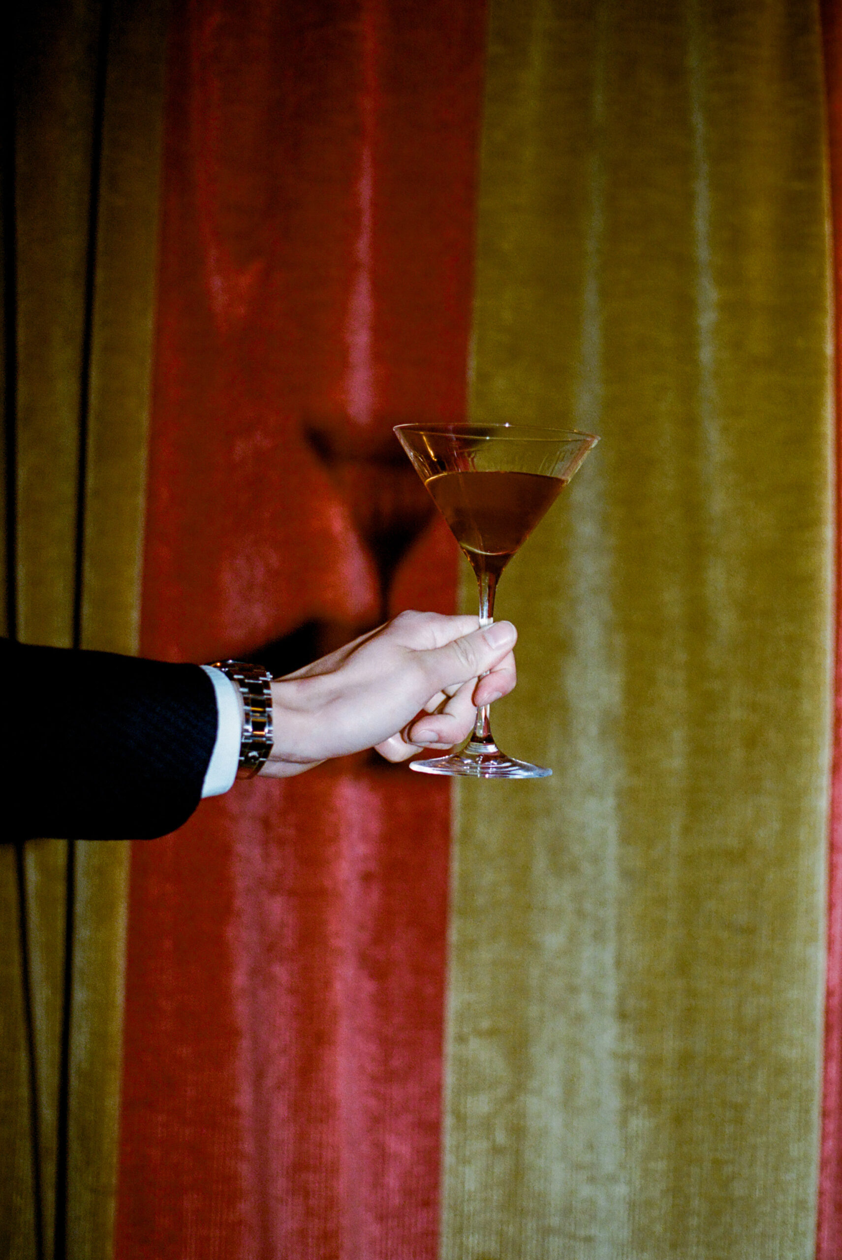 martini against velvet curtains at the Chelsea Hotel shot on 35mm film by parkers pictures