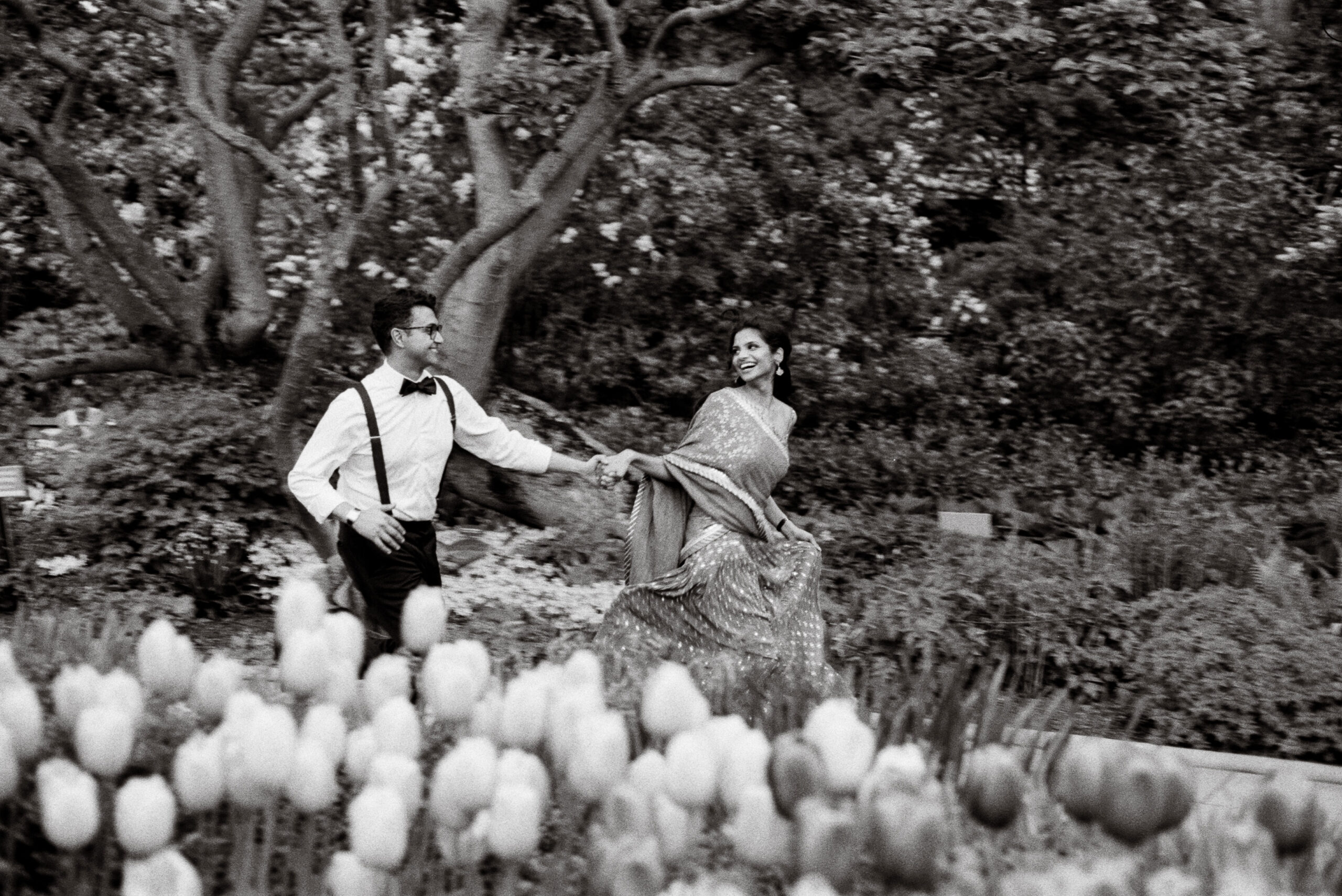 couple running through central park engagement in central park nyc shot on film by parkers pictures