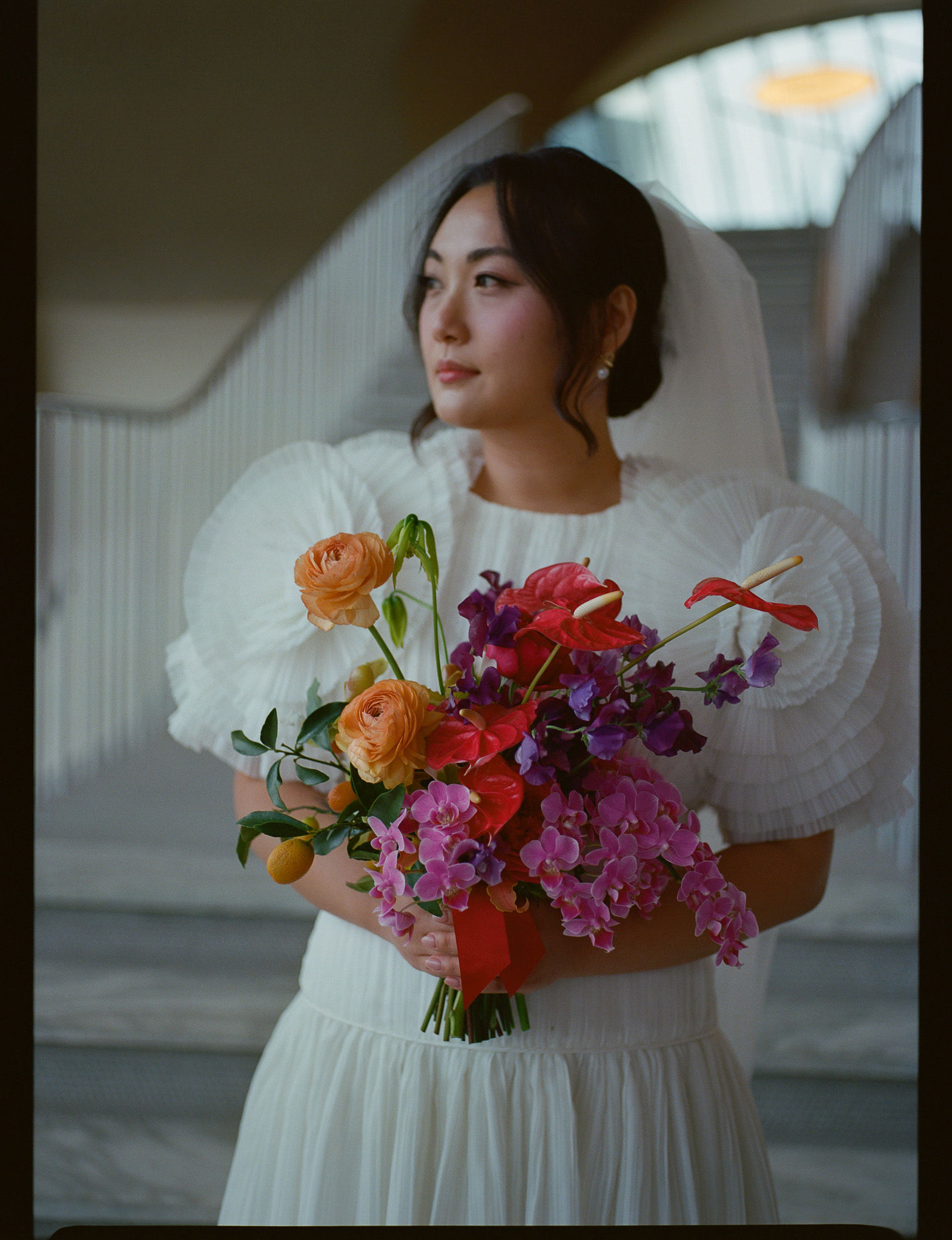 Bride with vibrant, colorful florals on medium format film taken by Parkers Pictures