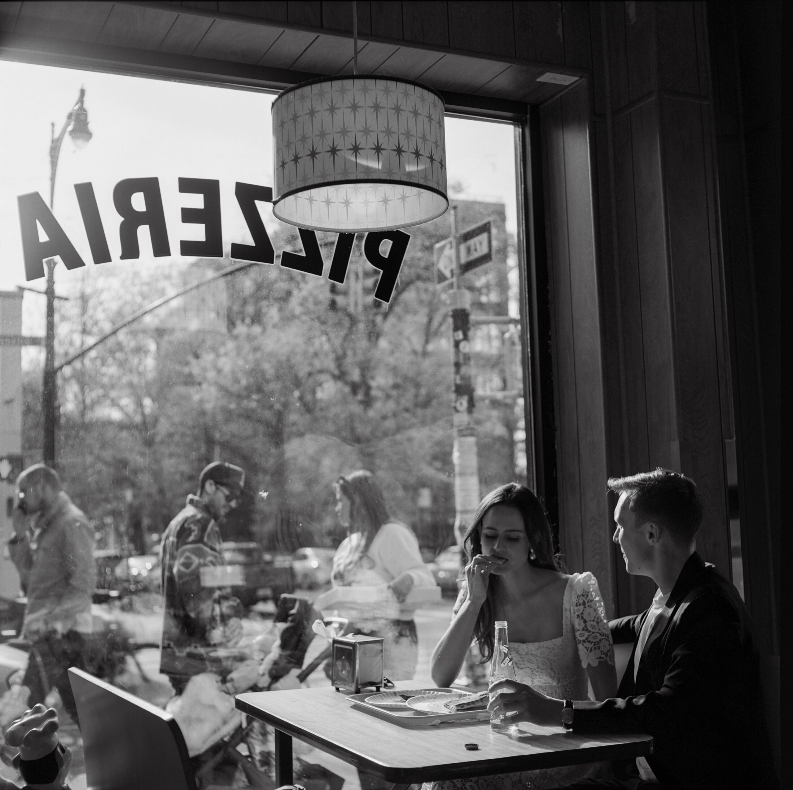 couple eating pizza engagement photo at Paulie Gee