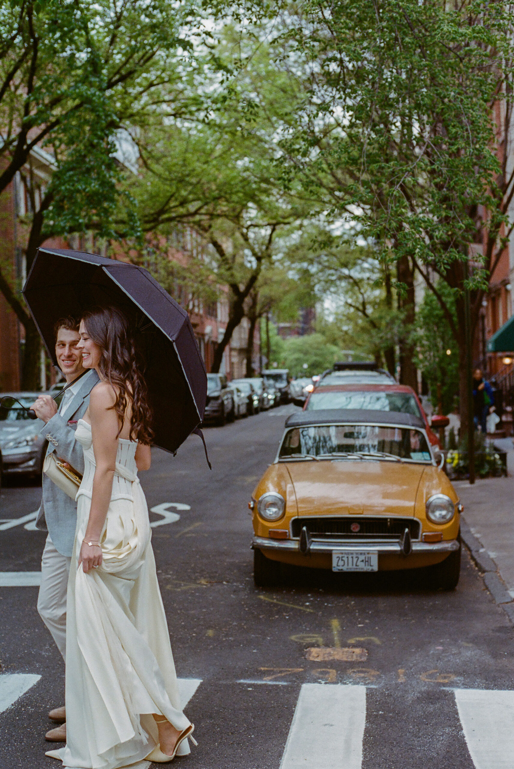 couple on street with vintage car engagement photo in the west village shot on film by parkers pictures